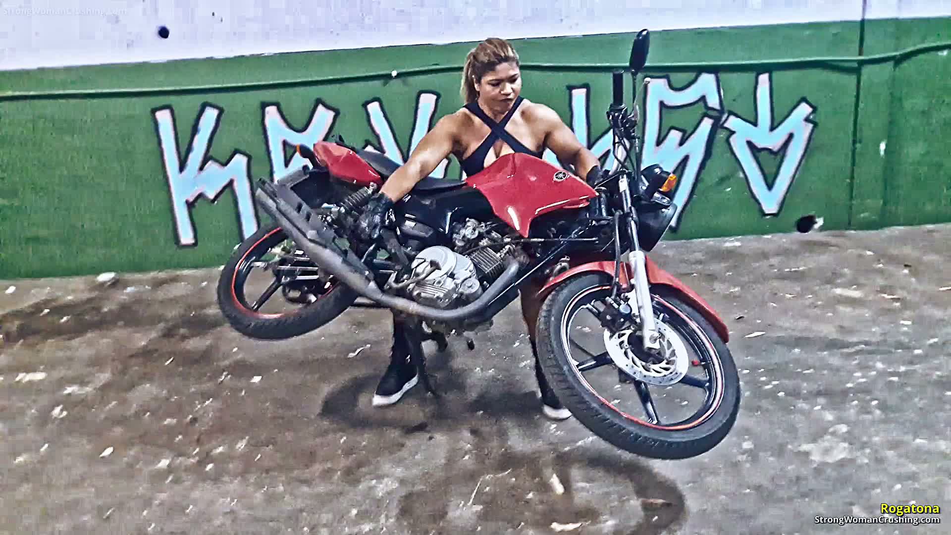 Rogatona lifts a motorcycle